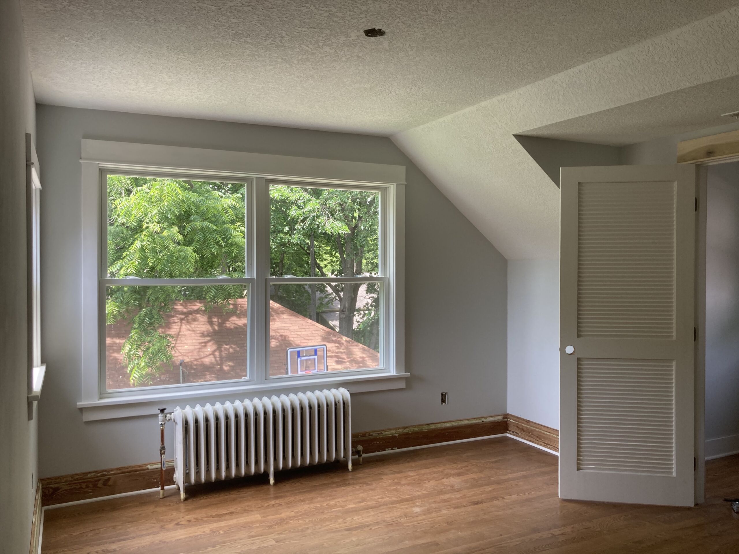 Interior of new addition; room with wooden floors and large windows