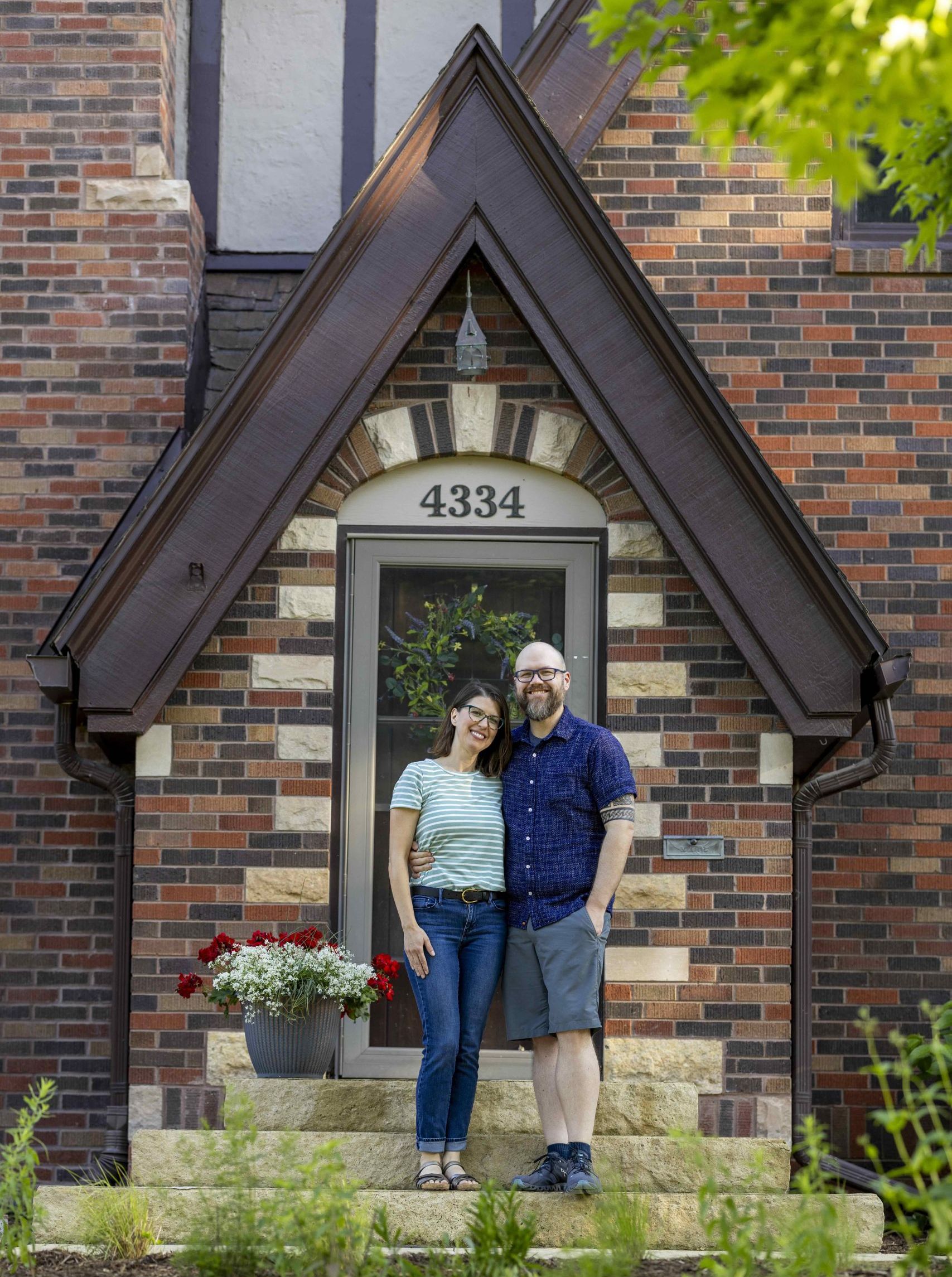 Leslie and Jeff Berckes in front of their Beaverdale Brick home